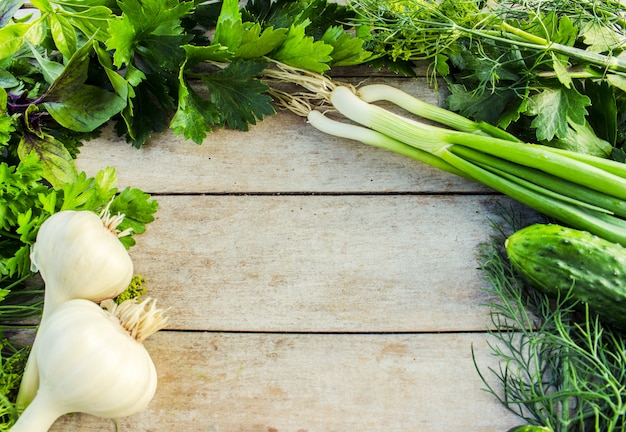 Green vegetables on a wooden background.