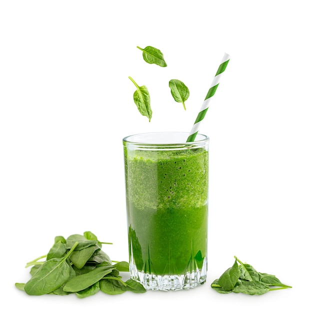 Green vegetarian fitness smoothie made of raw spinach leaves in glass isolated on white background