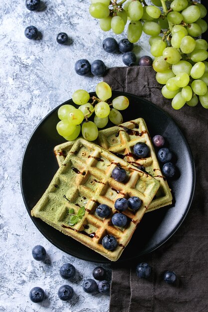 Green waffles with grapes