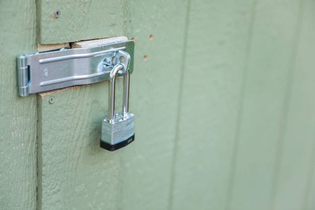 A green wall with a metal handle that says water temperature.