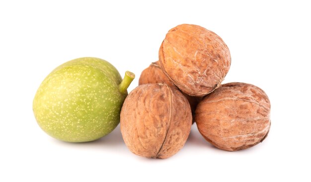 Green walnut, isolated on white background. Peeled walnut and kernels. Walnuts branch.