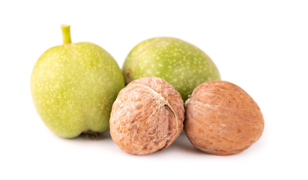 Green walnut, isolated on white. Peeled walnut and kernels.