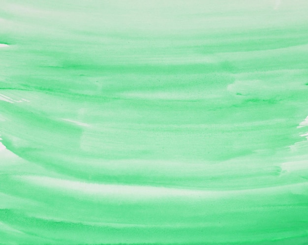 Green watercolor background hand painted by brush