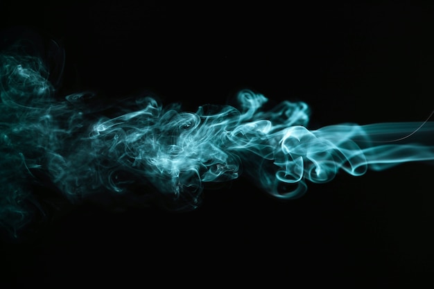 Photo green wavy smoke on black background