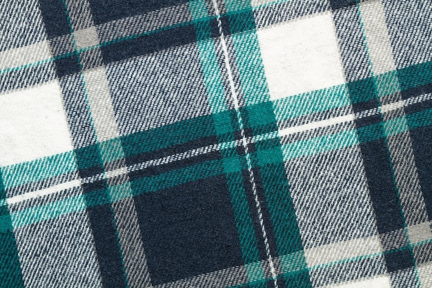 Green white and gray plaid fabric in a close up view