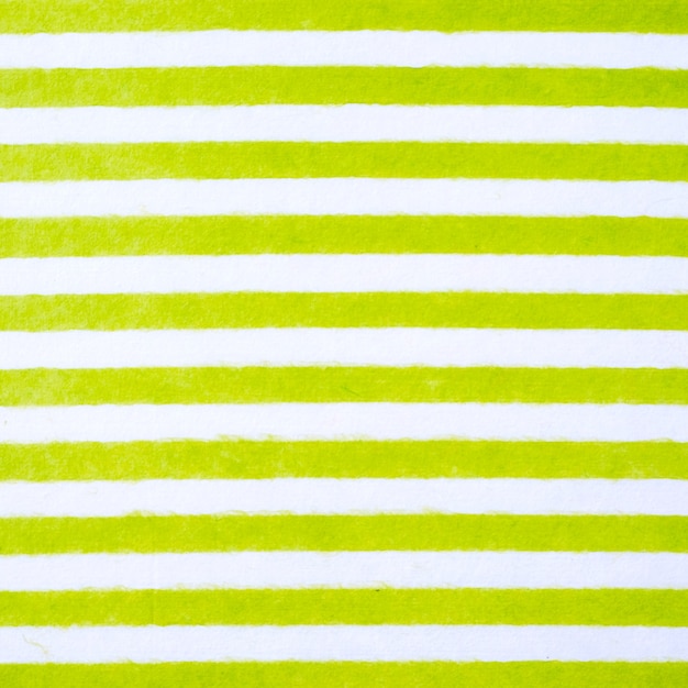 Green and white striped pattern on mulberry paper textured background, detail close-up