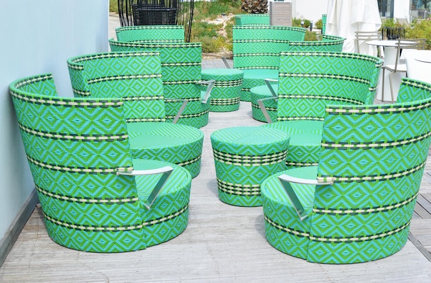 Green wicker chairs and table in a restaurant