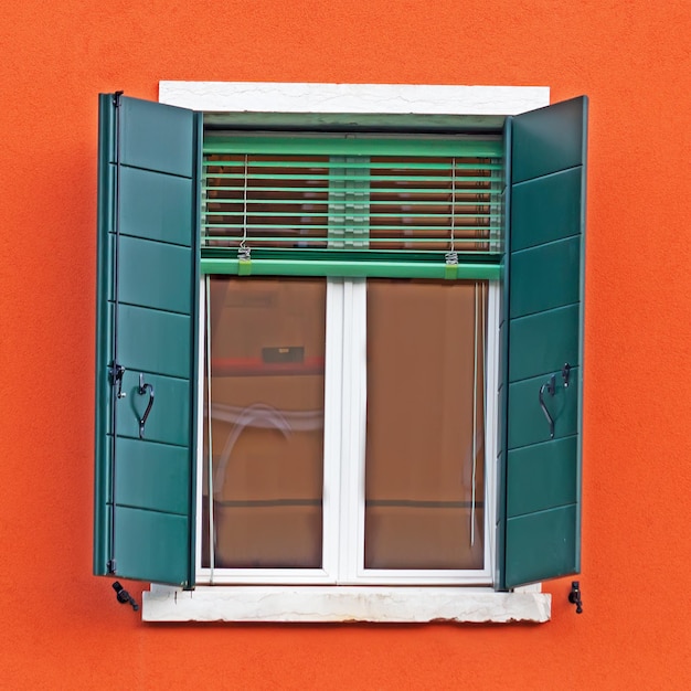 Green window in an orange wall