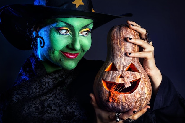 Green witch with pumpkin