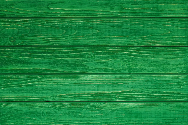 Green wood texture and background. Painted wooden surface. Timber planks