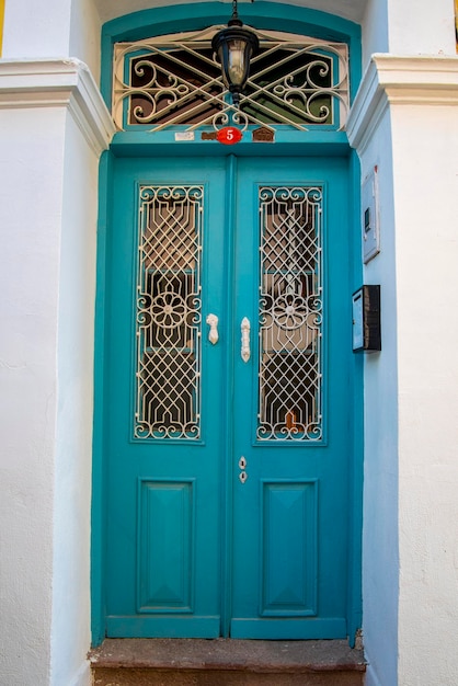 Green wooden door in the Turkish style of a stone house