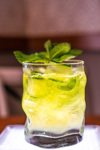 Green and yellow drink with mint and ice