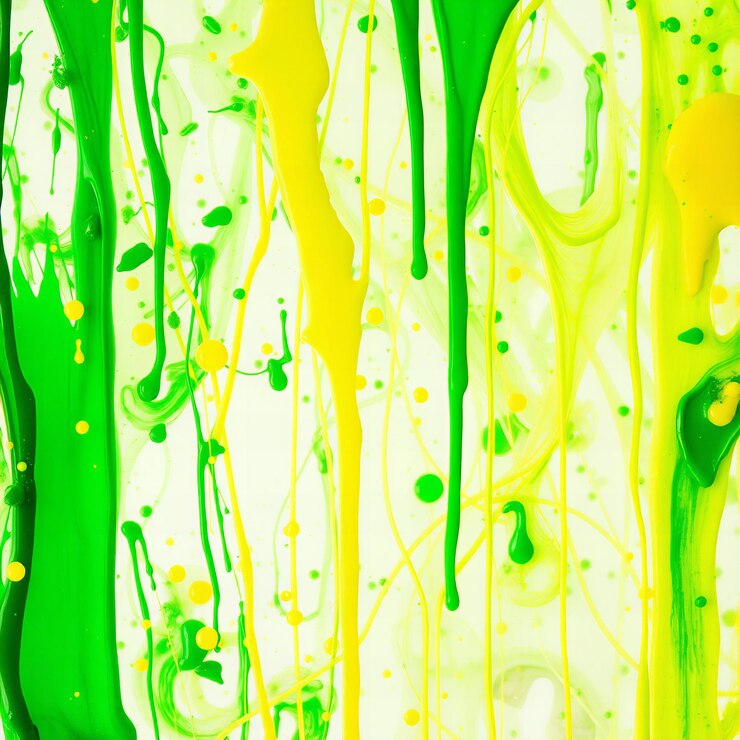 Photo green and yellow paint dripping on glass