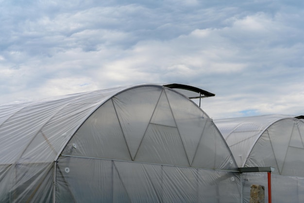 Greenhouses in Ukraine against the sky with clouds