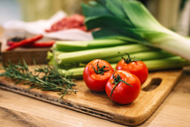 greens and vegetables on wooden boards.