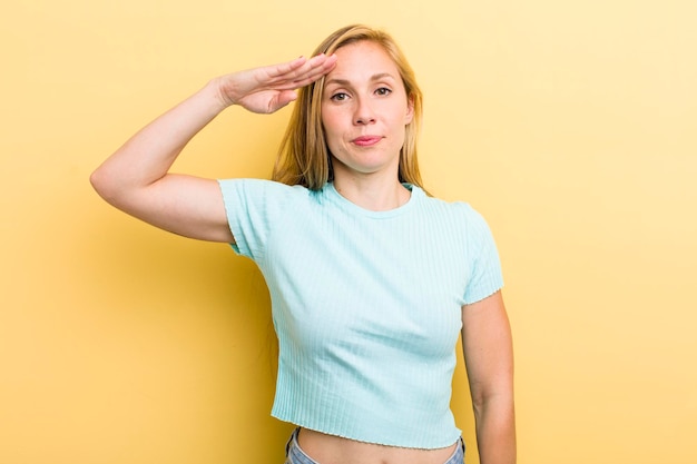 Greeting the camera with a military salute in an act of honor and patriotism showing respect