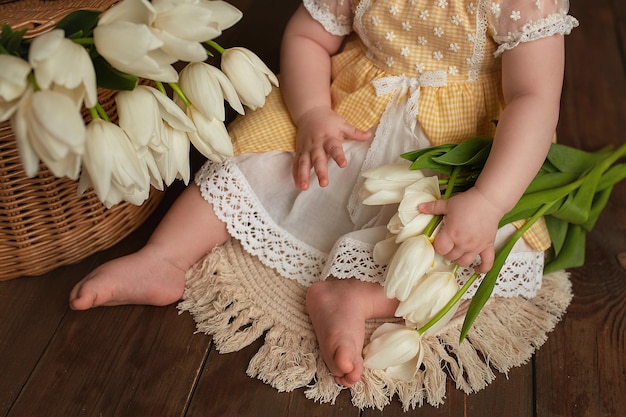 Greeting card Cute child with white tulips Mother's Day March 8 International Women's Day concept