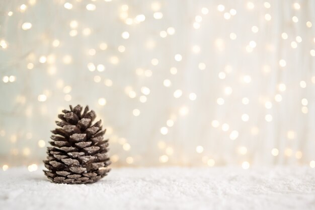  greeting card.fir cones on white snow. Winter background