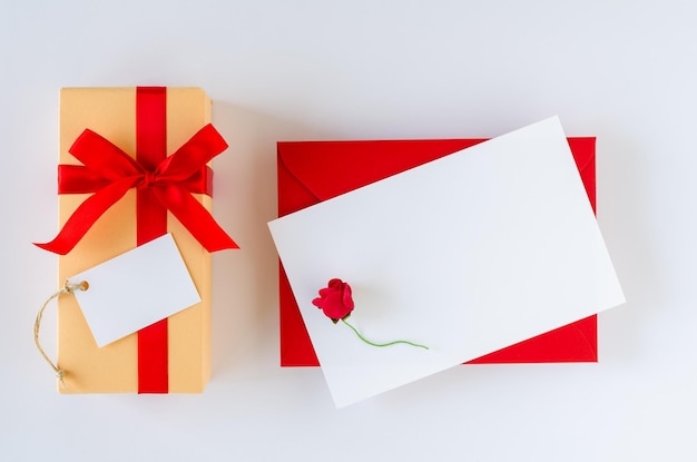 Greeting card and gift box on white background