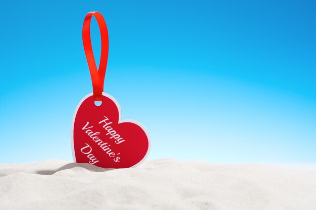 Greeting card happy Valentine's day heart shape on sand