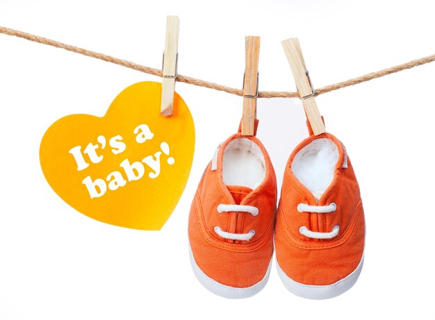 Photo greeting card 'it's a baby' baby's sneakers on a rope with clothespins