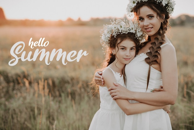 Greeting card with the inscription Hello Summer. Happy mother and daughter with flower wreaths