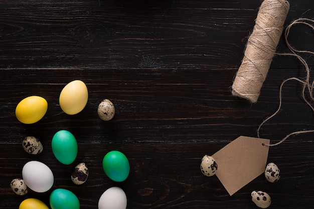 Greeting card with paschal eggs on rustic wood table