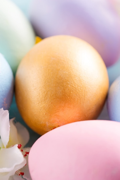 Greeting Easter card with close-up golden painted eggs.