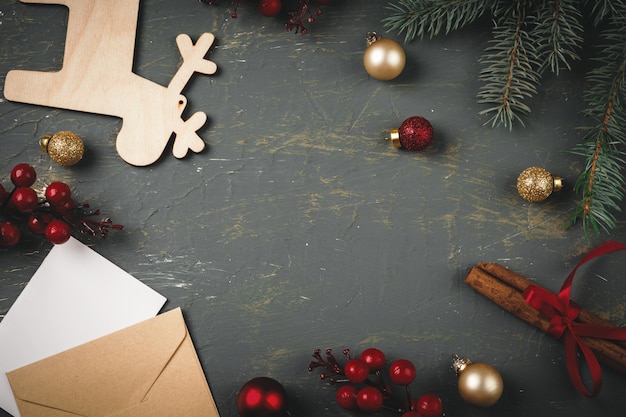 Greeting letter, envelope and feather  surrounded by Christmas decorations