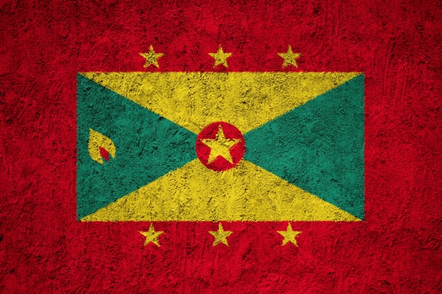 Photo grenada flag painted on grunge wall