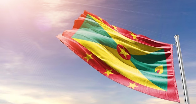 Grenada national flag waving in beautiful sky