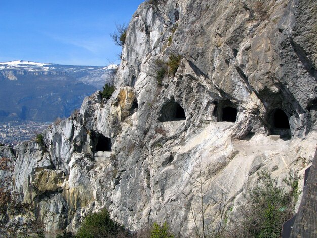 Grenoble, Bastille fortress. Mandrin caves in mountains in front of fort. Many entrances to caves