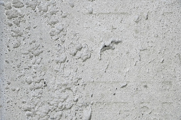 Grey background of concrete plaster uneven rough surface