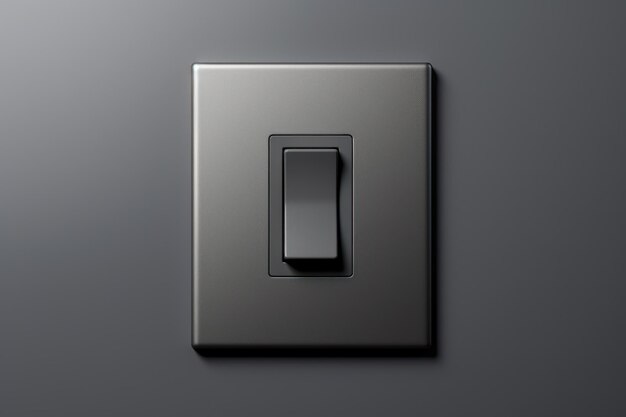 A grey background with a black light switch