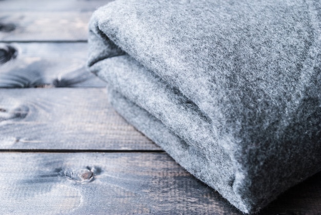 Grey blanket on a wooden background