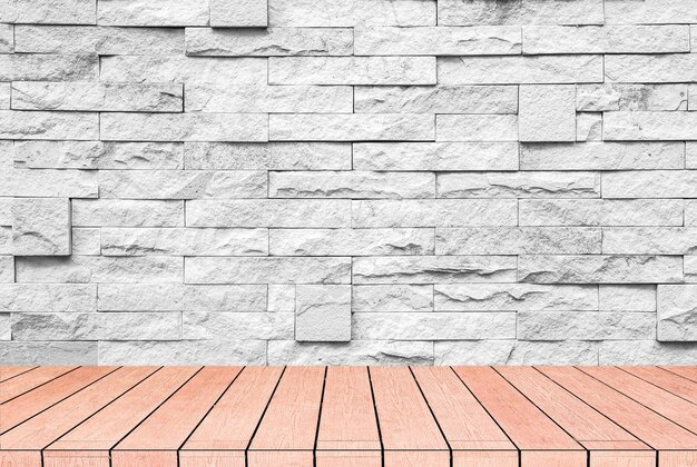 Grey brick and stone wall with warm brown wooden floor.