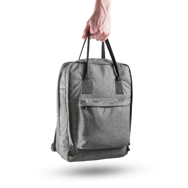 Grey casual backpack in the human hand Fabric rucksack with handles front view