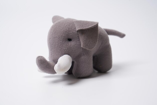 Grey colored toy elephant on a white background