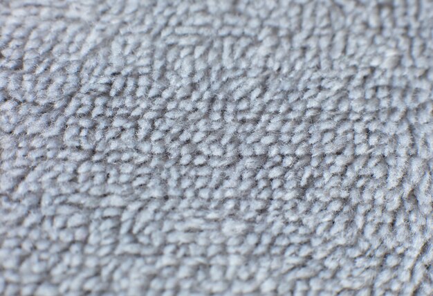 Grey cotton towel or carpet
fluffy texture background. Close up photo.