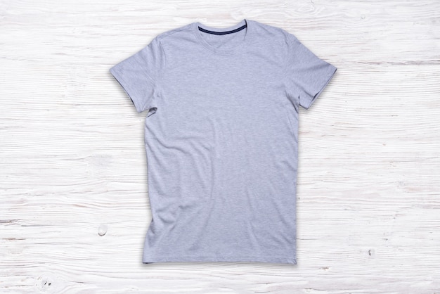 Grey cotton Tshirt on wooden background,