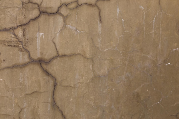 Grey dirty cracked plaster wall flat texture and full frame\
background