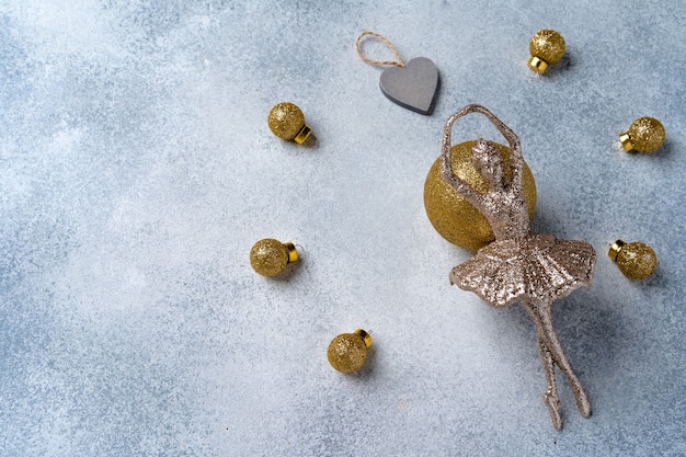 Grey and gold Christmas baubles on frosted