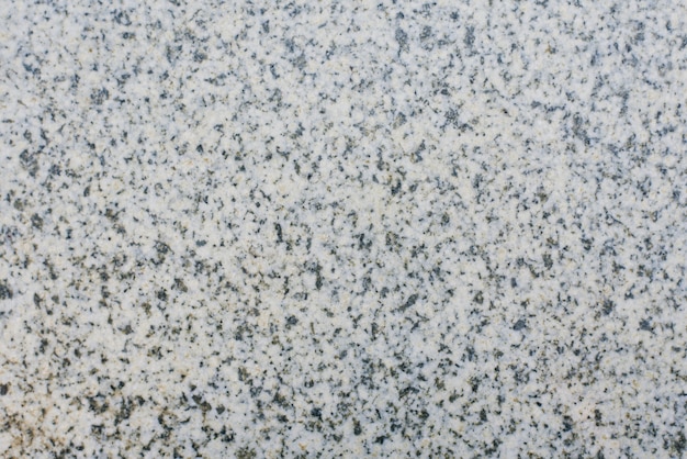 Grey granite background with black grains