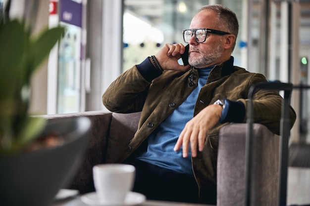 Grey-haired Caucasian man making a phone call