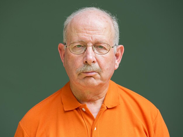 Grey haired senior man with mustache wearing eyeglasses