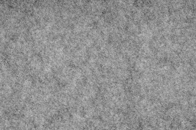 Photo grey heather knitted fabric made of synthetic fibres textured background. grey knitted fabric texture. background with delicate striped pattern, close up