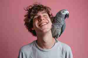 Photo grey jaco pet parrot sitting mans shoulder portrait male domestic african parakeet plain background