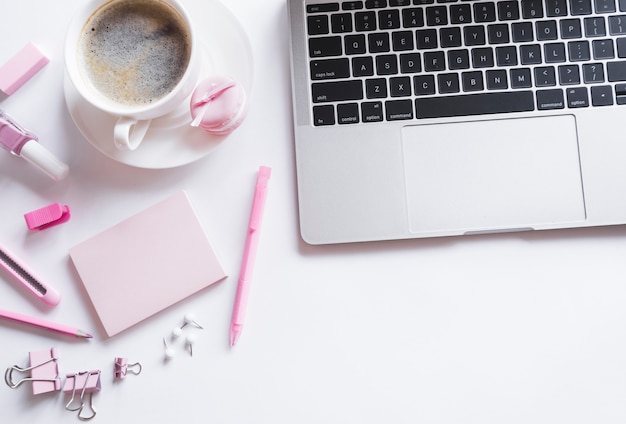 Photo grey laptop with pink stationery