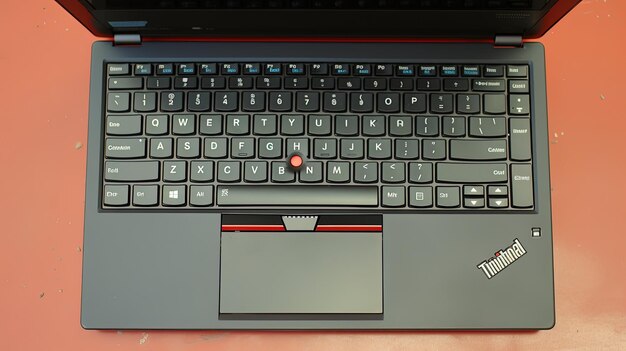 Photo a grey laptop with a red button that says macbook pro