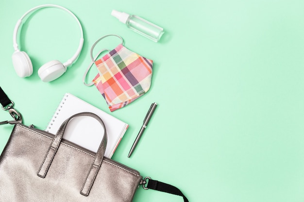 Grey leather backpack with school supplies and Personal protective equipments.